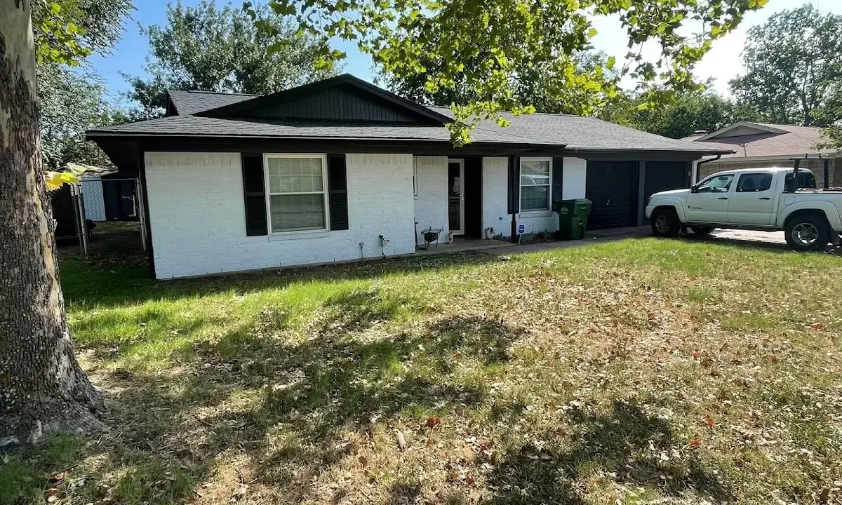 Professional roofing crew working on a residential roof in Woonsocket